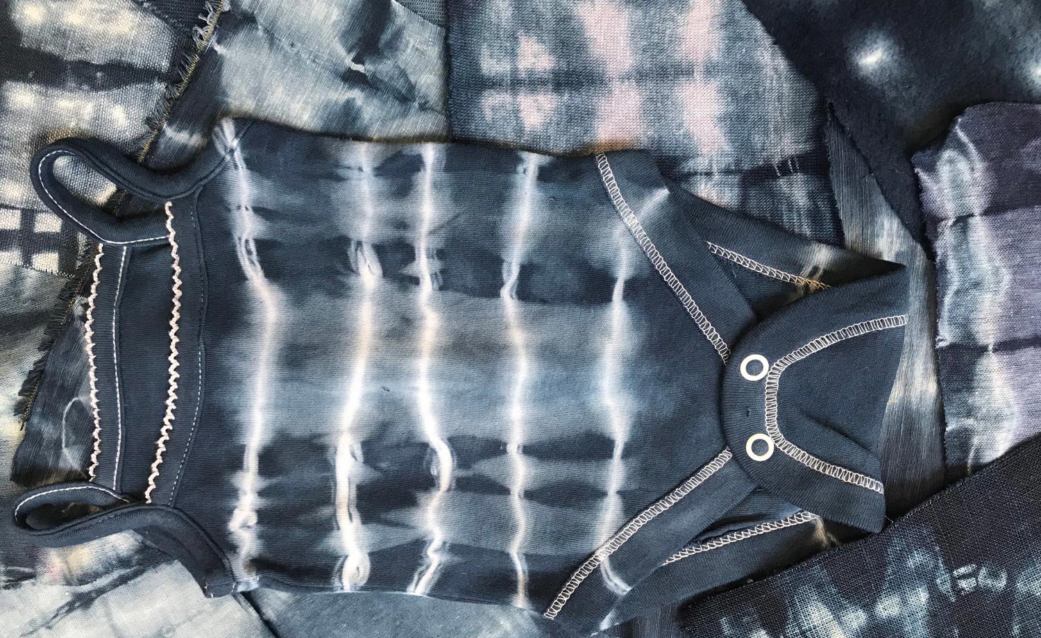 Blue and white resist dyed babygrow and samples